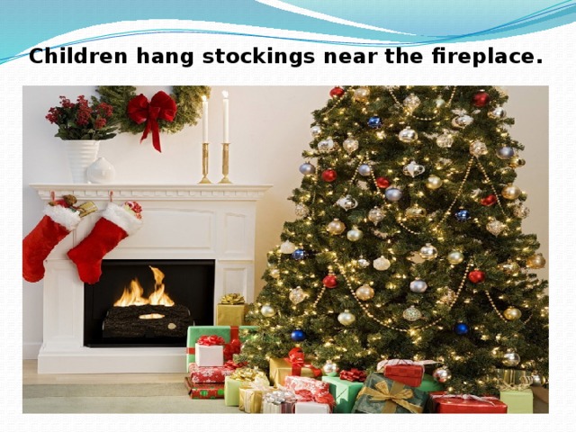 Children hang stockings near the fireplace. 