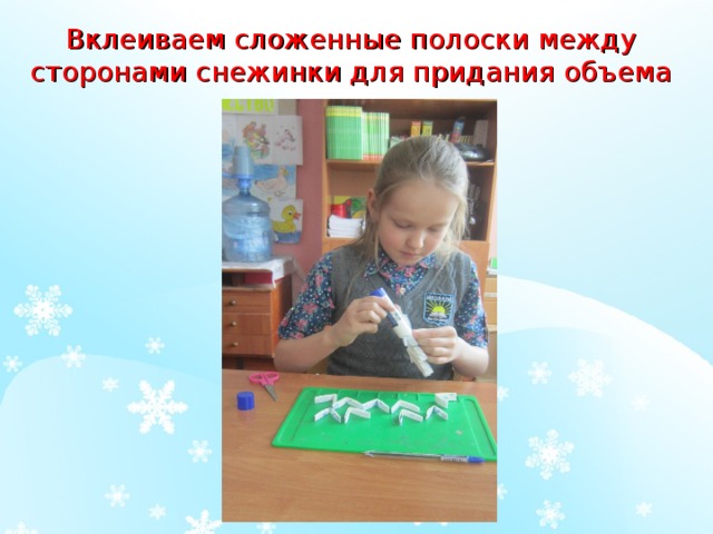 Вклеиваем сложенные полоски между сторонами снежинки для придания объема 