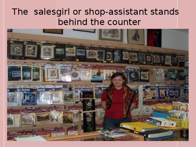 The salesgirl or shop-assistant stands behind the counter 