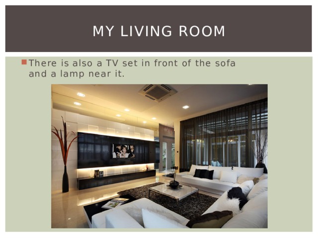 My living room There is also a TV set in front of the sofa and a lamp near it. 