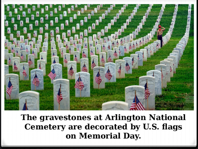 The gravestones at Arlington National Cemetery are decorated by U.S. flags on Memorial Day. 