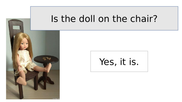 Is the doll on the chair? Yes, it is. 