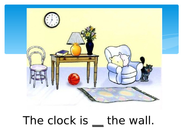 The clock is __ the wall. 