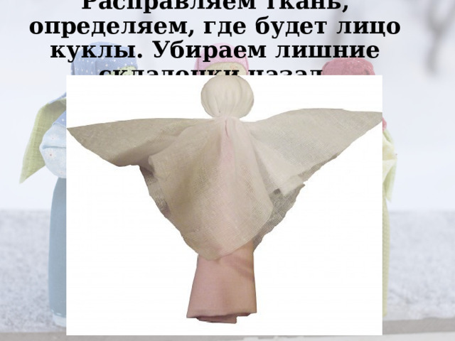 Расправляем ткань, определяем, где будет лицо куклы. Убираем лишние складочки назад.   