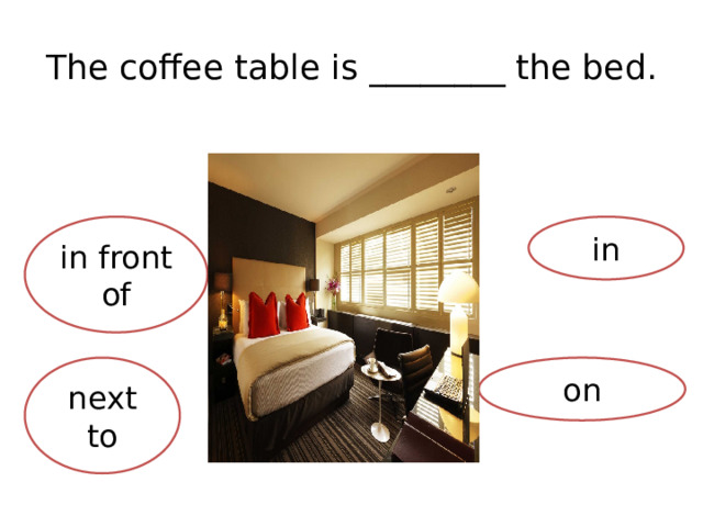 The coffee table is ________ the bed. in front of in on next to 